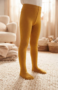 Collants jaune moutarde unis pour enfant présentés portés avec pieds