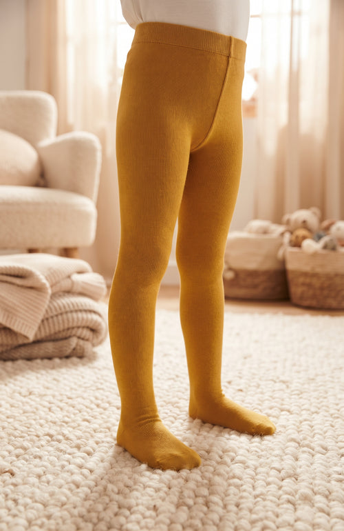 Collants jaune moutarde unis pour enfant présentés portés avec pieds